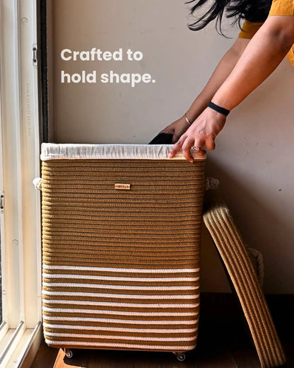 Woven storage baskets with a rope handle on a wooden floor.